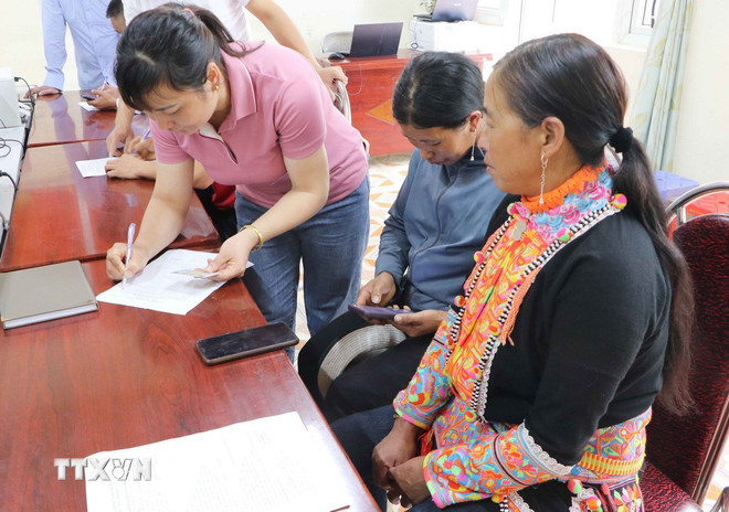 Trung tâm phục vụ hành chính công xã biên giới Sì Lở Lầu (tỉnh Lai Châu) phục vụ người dân đến làm thủ tục trong ngày làm việc đầu tiên. (Ảnh: Nguyễn Oanh/TTXVN)
