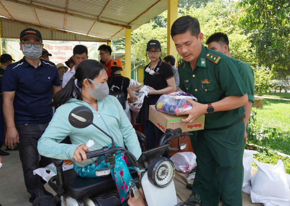 Trung tá Bùi Ngọc Thiệp - Chính trị viên Đồn Biên phòng Sông Trăng trao quà cho hộ dân có hoàn cảnh khó khăn