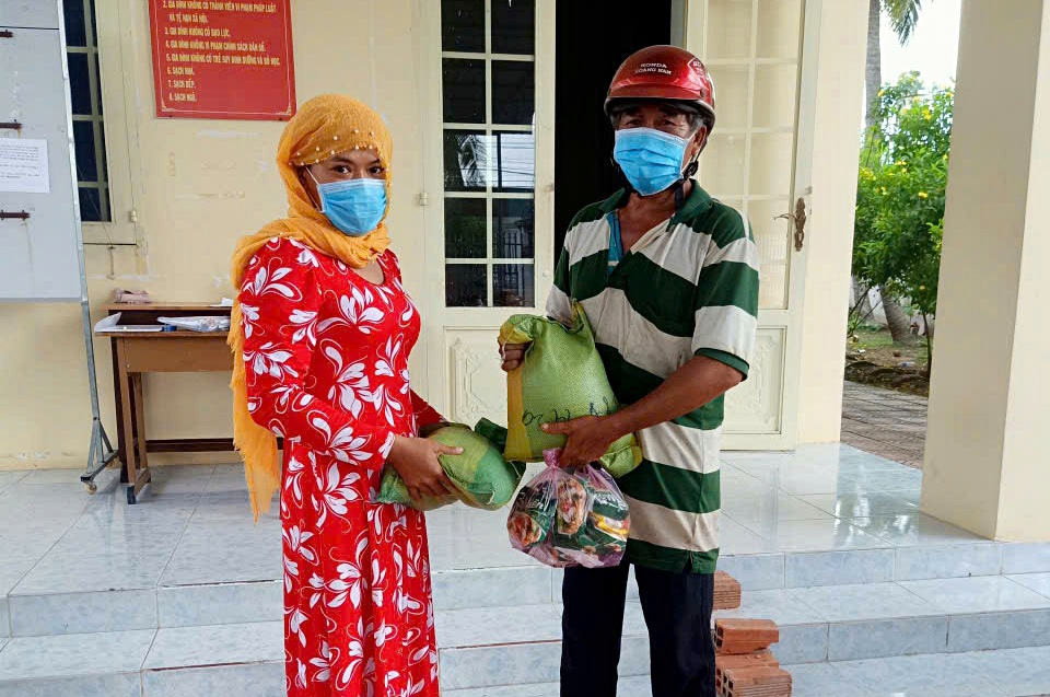 Chị Ên Ha Si Na trao quà cho người dân